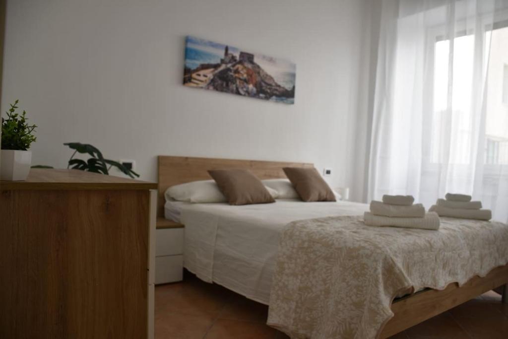 a bedroom with a bed with towels on it at Sunny Apartment in La Spezia