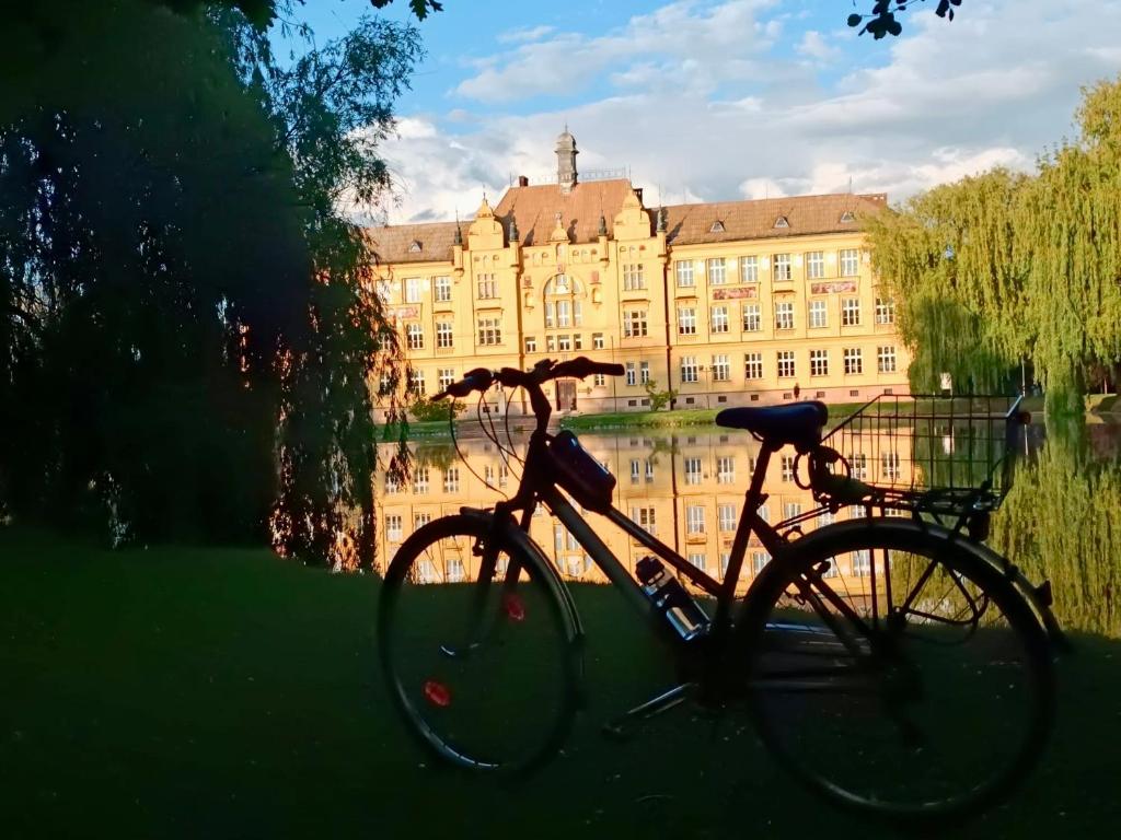 a bike parked in front of a large building at Apartmány u Litovelského Pomoraví in Olomouc