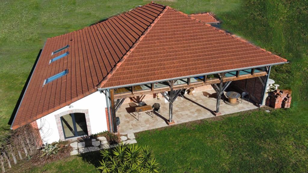 an overhead view of a house with a red roof at La Grange d'Hardy in Soustons