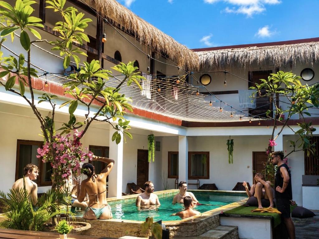 a group of people in the swimming pool of a hotel at Gili Pirates Dive & Social Hostel in Gili Trawangan