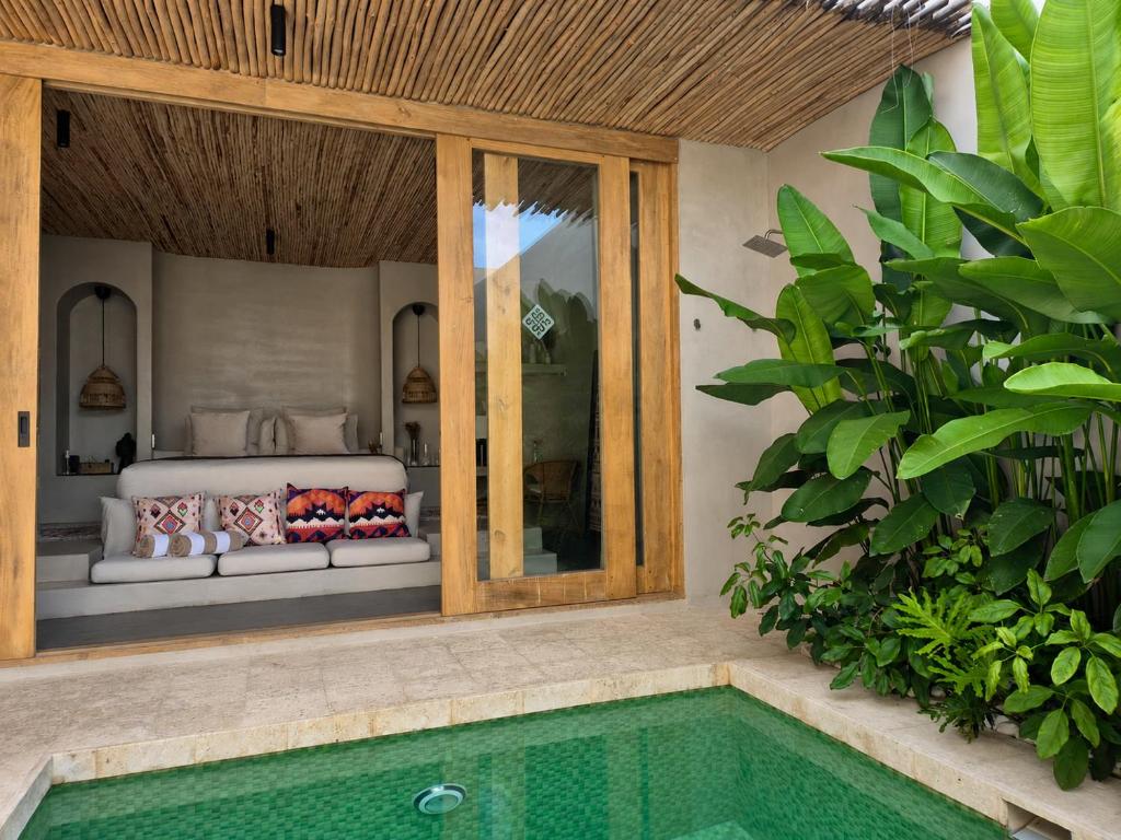 a bedroom with a bed and a swimming pool at El Salao Villas in El Nido