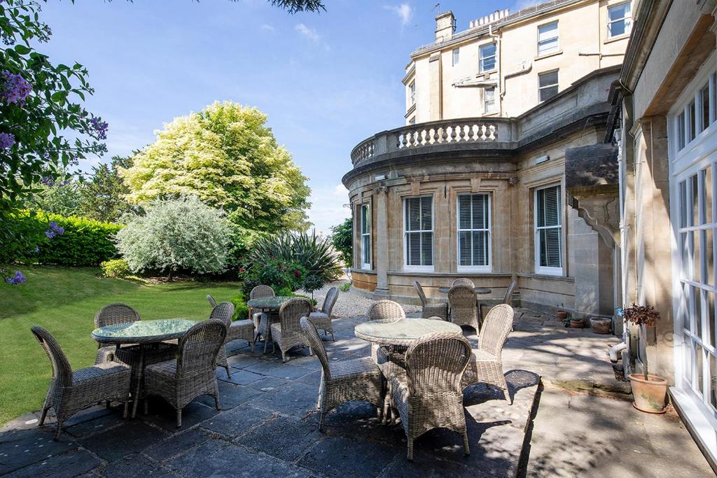 a patio with tables and chairs in front of a building at Lansdown Grove Hotel in Bath