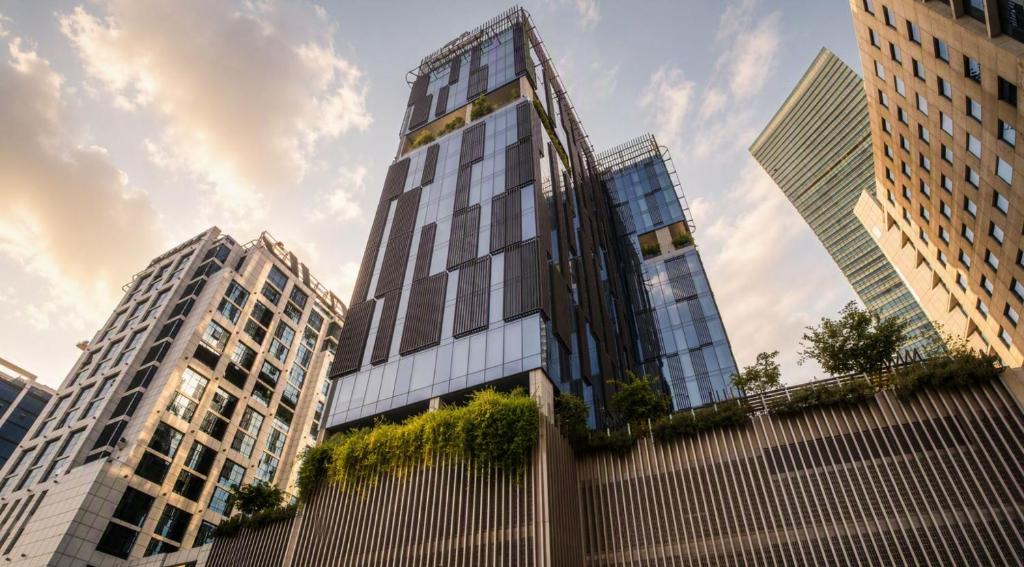 a tall building in a city with tall buildings at Barcelo Business Bay Dubai in Dubai