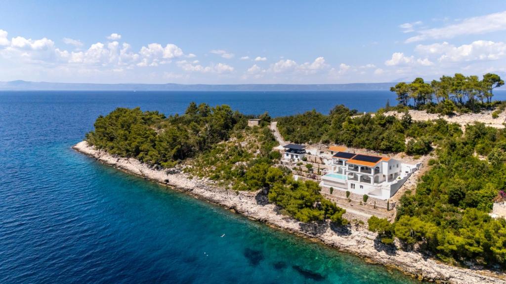 an aerial view of a house on an island in the water at Villa Christy in Čara