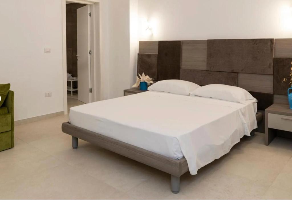 a bedroom with a large white bed with two pillows at Vie Del Salento in San Pancrazio Salentino