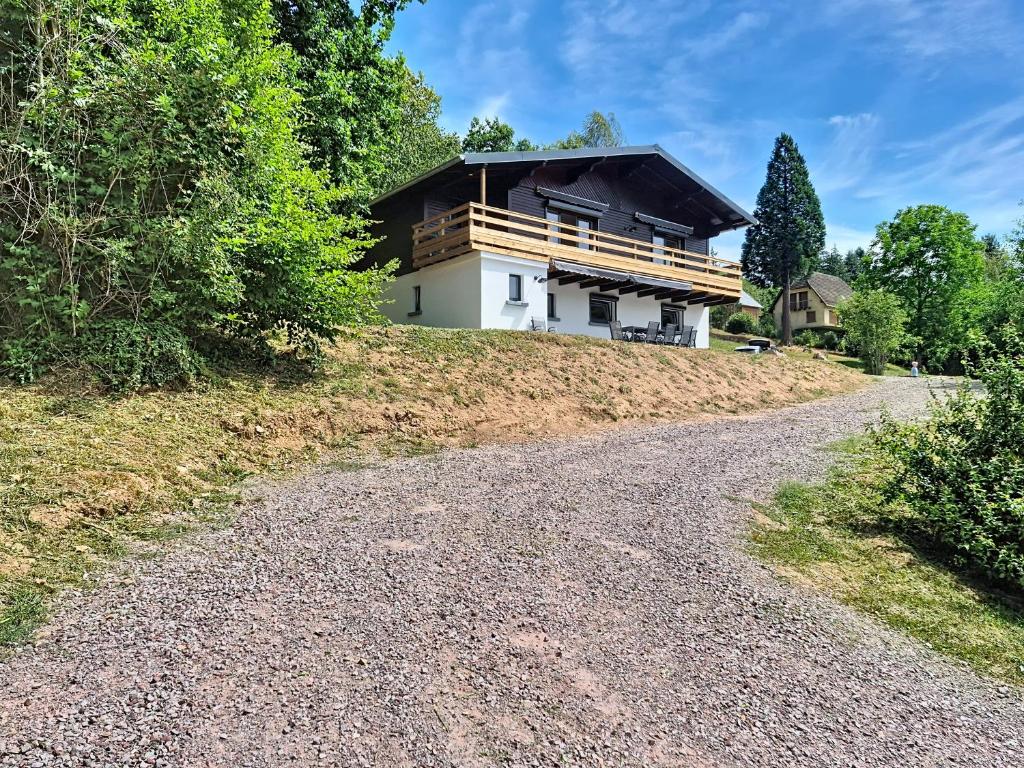 a house on a hill with a gravel road at Maison 8 pers rénovée nature, calme, proche Vosges in Colroy-la-Roche