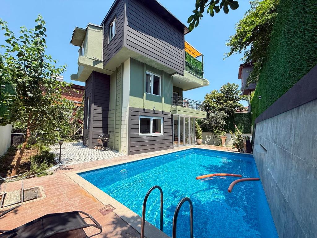 a house with a swimming pool in front of a house at Luxury villa in mountain in Geyikbayırı