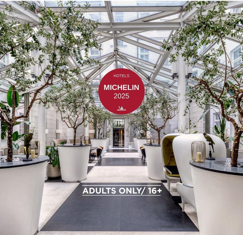 a view of the lobby of a high rise building with trees at H15 Boutique Hotel, Warsaw, a Member of Design Hotels in Warsaw