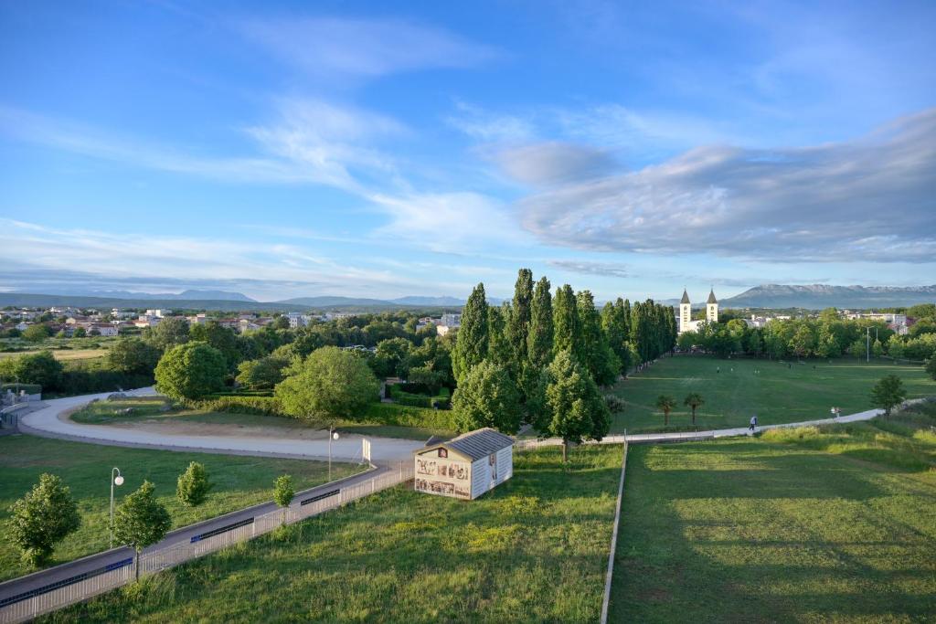 an aerial view of a park with a house and a road at Hotel 81 in Međugorje
