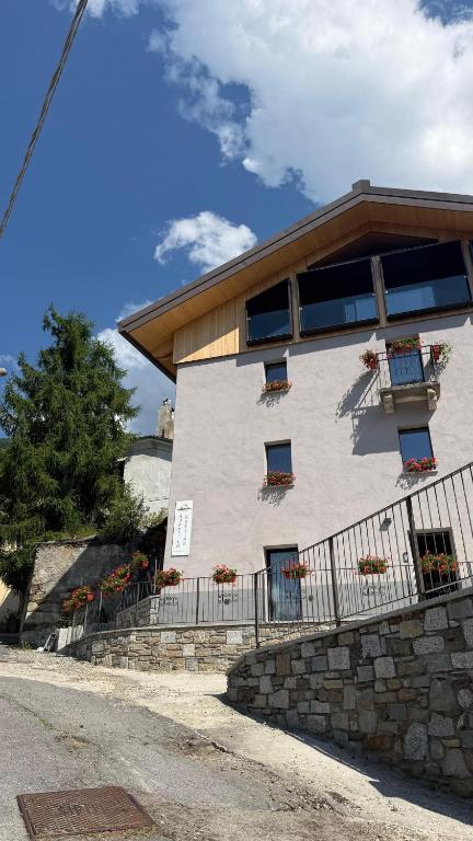 a building with windows and a fence in front of it at Adamello skyline in Temù
