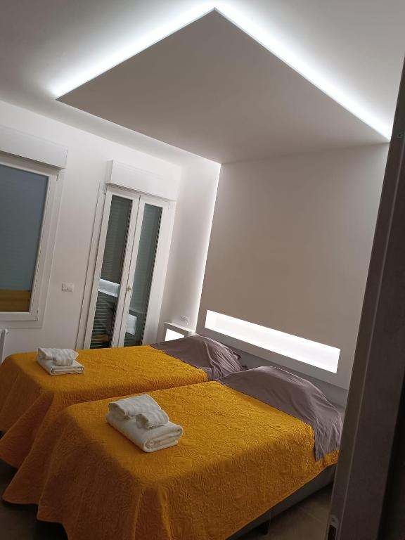 a room with a bed with two towels on it at CIVICO 14 Holiday Rooms in Suzzara