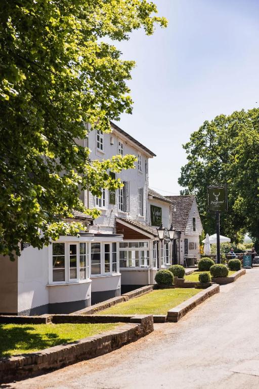 a white house with windows and a street at The Haughmond in Upton Magna