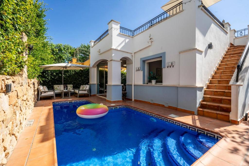 a villa with a swimming pool and a house at Casa Cedro - Modern Golf Resort in Torre-Pacheco