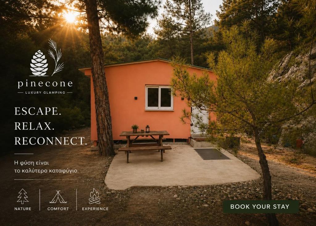 a house with a picnic table in front of it at Pinecone Luxury Glamping in Louvaras