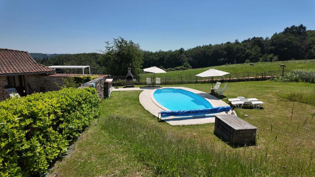 a swimming pool in the middle of a yard at Domaine de Bellac - Le Triangle in Roussines