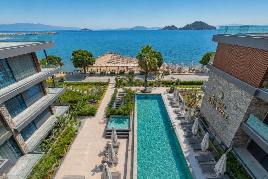 an aerial view of a resort with a swimming pool and the ocean at Bodrum Ada Suites Beach Hotel in Turgutreis