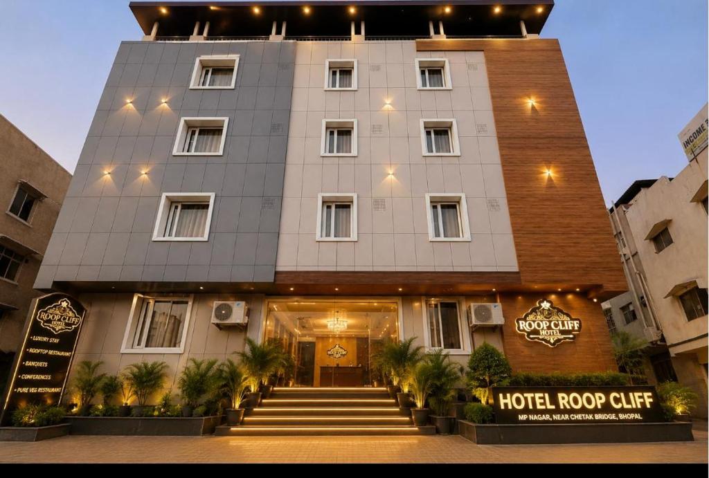 a hotel building with stairs leading to the door at Hotel Roop Cliff, Bhopal in Bhopal