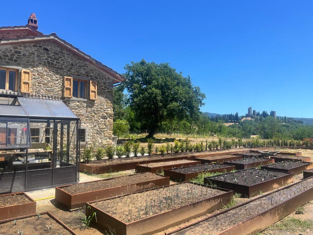 a row of raised garden beds in front of a building at Vista Romena in Pratovecchio