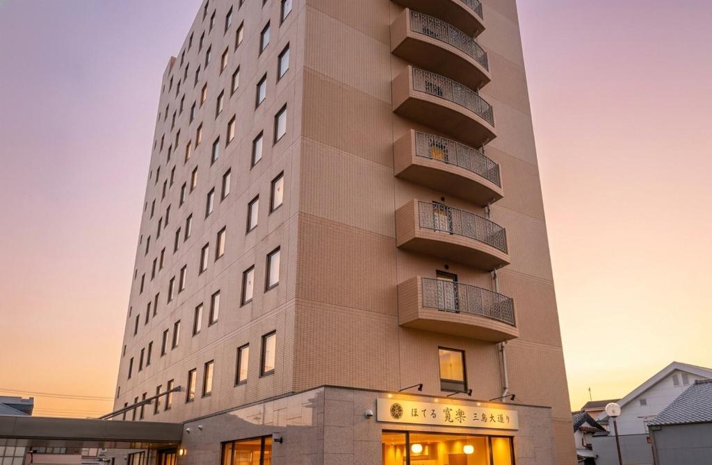 a building with balconies on the side of it at HOTEL KAN-RAKU Mishima Main Street in Mishima