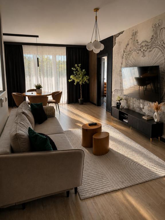 a living room with a couch and a table at Park Vista in Szczecinek