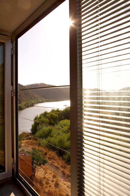 a window in a room with a view of a river at Casa de las Letrinas Alta, 2 Habt 5 más 1 Pers max chimenea con horno in Puerto de la Laja