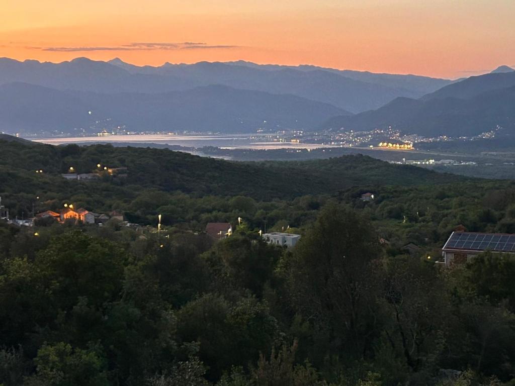 a view of a city and a lake at sunset at Maginja house in Milojci