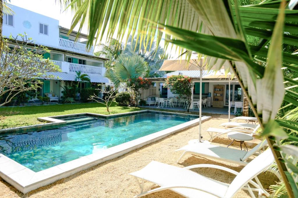 a swimming pool in front of a building at Le Mandala Moris Boutique Hotel in Grand-Baie