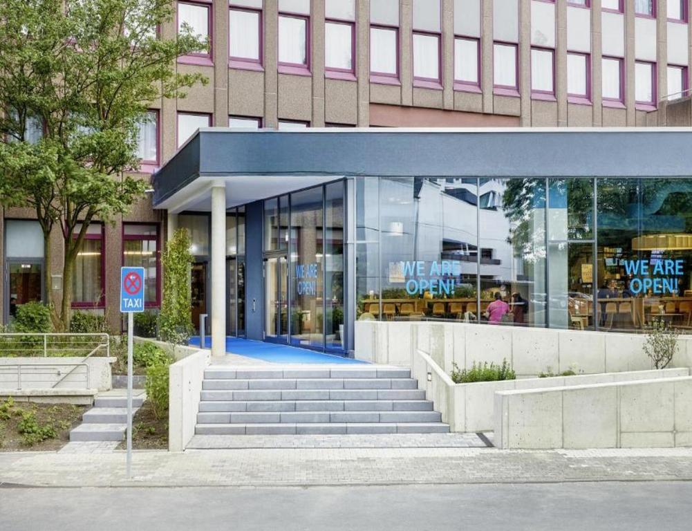 a building with a glass entrance to a store at Sunday Hotel Düsseldorf Seestern in Düsseldorf