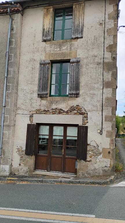 an old building with two doors and two windows at Number 33 Village house in Rancon sleeps 4 in Rancon