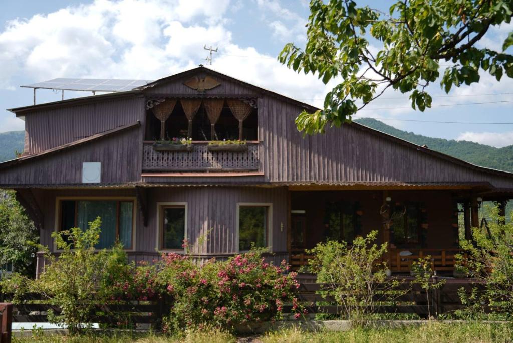 a large wooden house with a balcony at ARTSIV Guesthouse in Dilijan