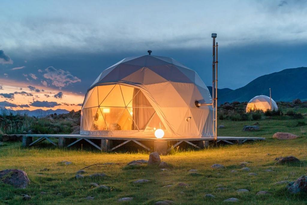 a dome tent sitting in a field at sunset at Old stones glamping in Chok-Tal