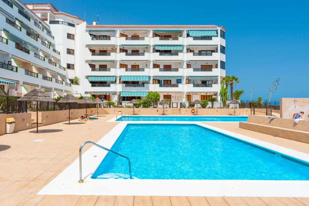 a swimming pool in front of a building at Atlantic Sky Panorama in Costa Del Silencio