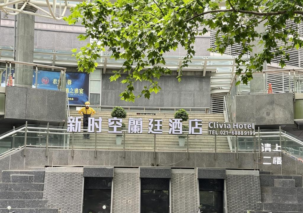 a man standing on top of a building at Shanghai Clivia Hotel in Shanghai