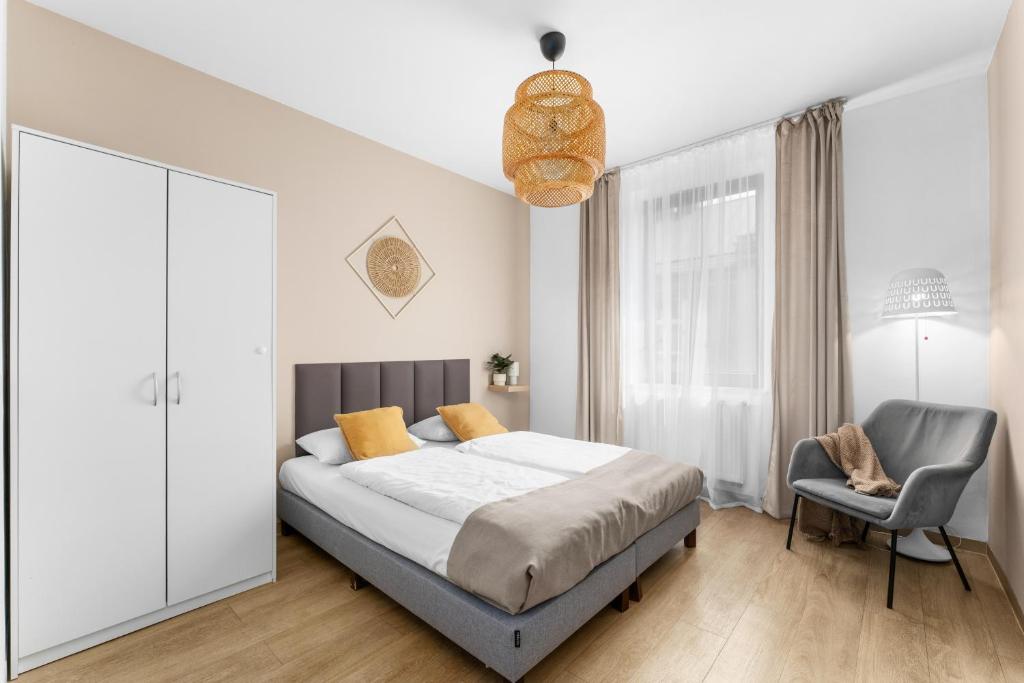 a bedroom with a bed and a chair at Friendhouse Residence in Krakow