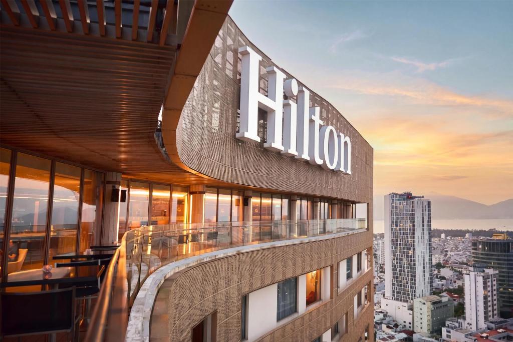 a building with a hilton sign on the side of it at Hilton Da Nang in Danang
