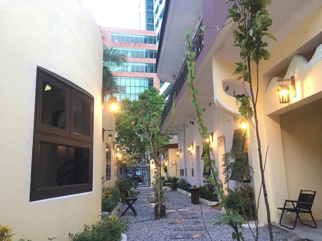 an alleyway between two buildings with trees and lights at BalaHomestay BalaHouse in Lạc Thành