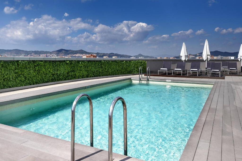 a swimming pool on the roof of a building at Hotel Barcelona Condal Mar, Affiliated by Meliá in Barcelona