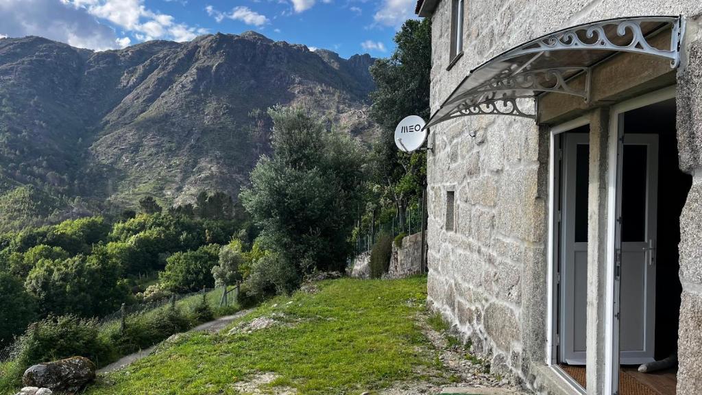 a building with a window with a view of a mountain at Vale Das 7Lagoas in Geres