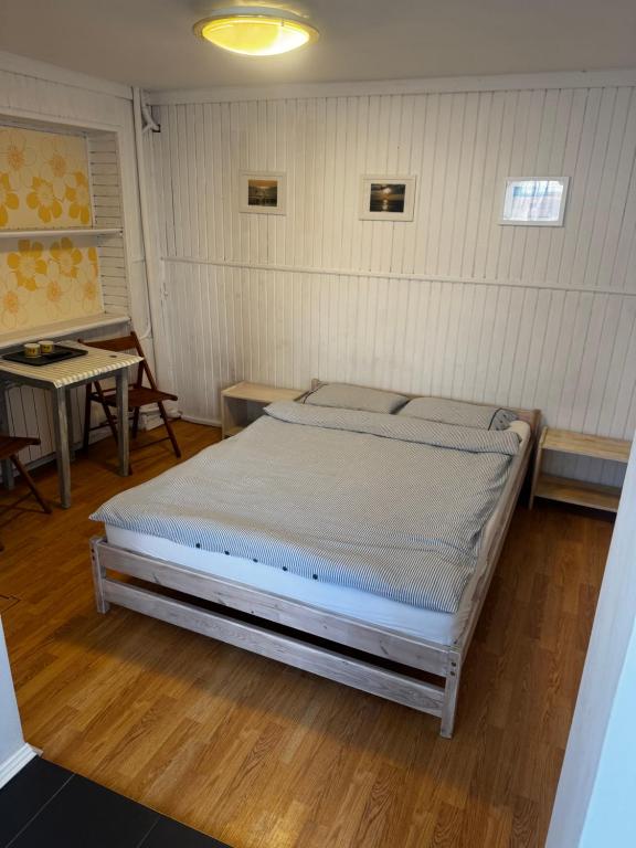a bedroom with a bed in a room with a table at U Jaśka in Darłowo