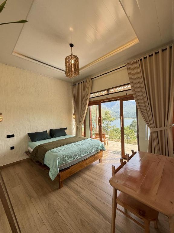 a bedroom with a bed and a table in it at Slash Villa in Silimapuluh