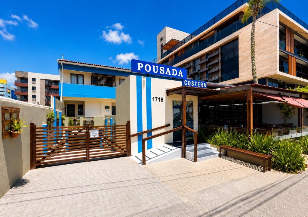a building with a sign that reads pueblula street at Pousada Costera in João Pessoa