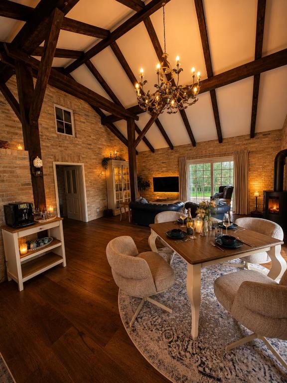 a large living room with a table and chairs at Landhaus Sweet Escape in Löningen