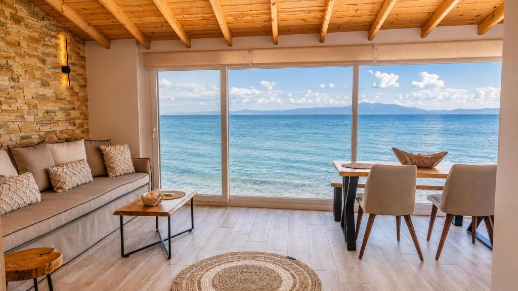 a living room with a view of the ocean at Navis Luxury in Skala Kallirachis