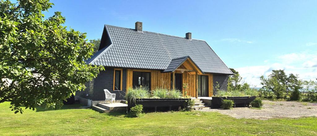 a small house with a chair in front of it at Kõpu Seaside Getaway in Rannaküla