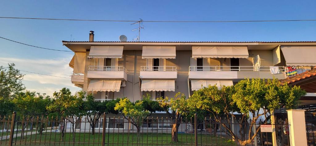a building with balconies and trees in front of it at K SANTIS STUDIOS in Pefki