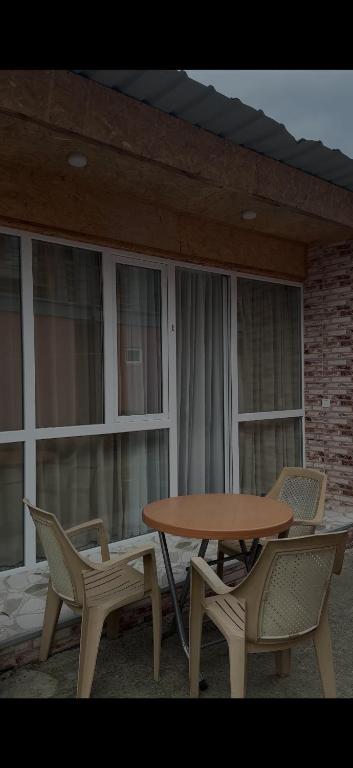 a table and two chairs and a table and some windows at Hotel barbie Cottage #1-2 in Ureki
