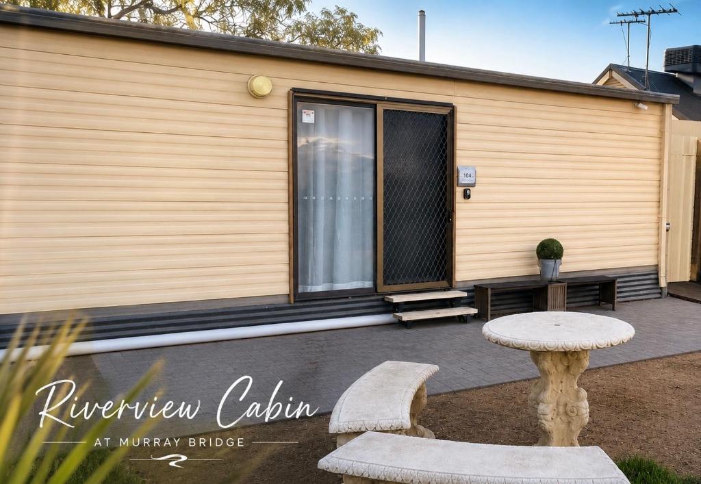 a tiny house with a window and a table at Murray Bridge Riverview cabin in Murray Bridge