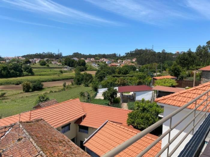 an overhead view of roofs of buildings with trees at Casa Mamosteira Apartamento Refugio in Sandim