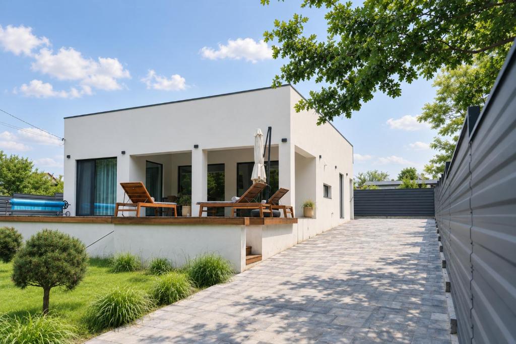 a white house with a patio and lawn at Wild River 2 in Neporotovo