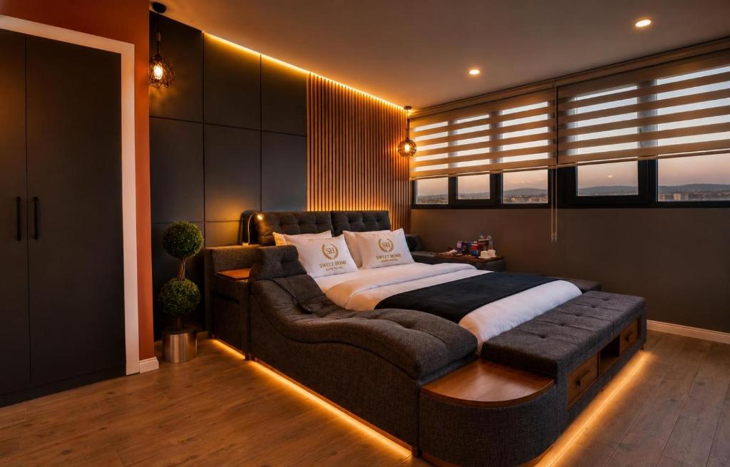 a bedroom with a large bed and a couch at SWEET HOME SUiTE HOTEL in Trabzon